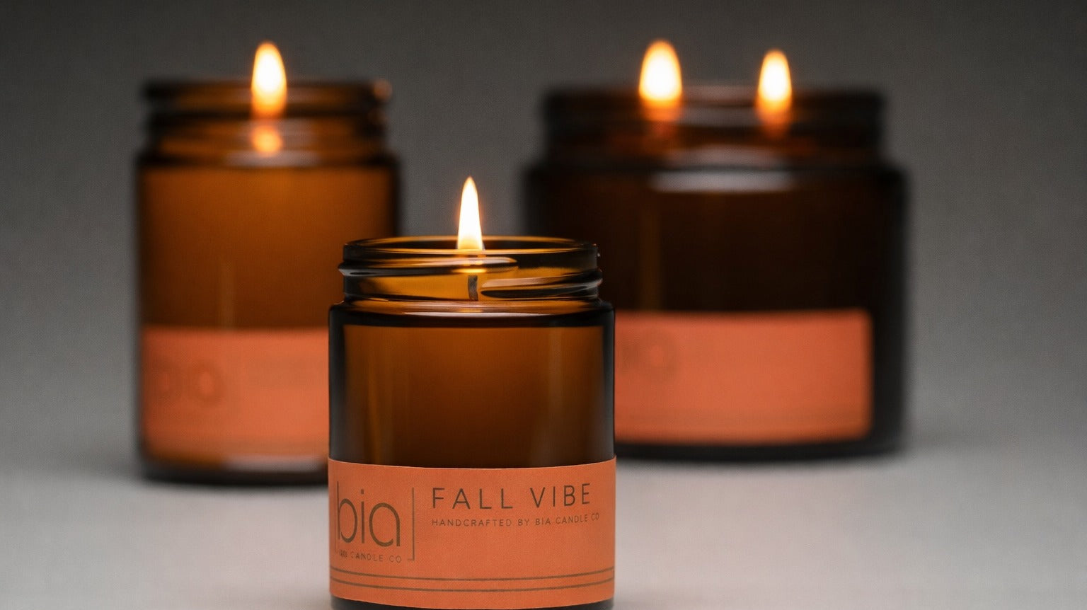 fall vibe candles lit in 3 different sizes