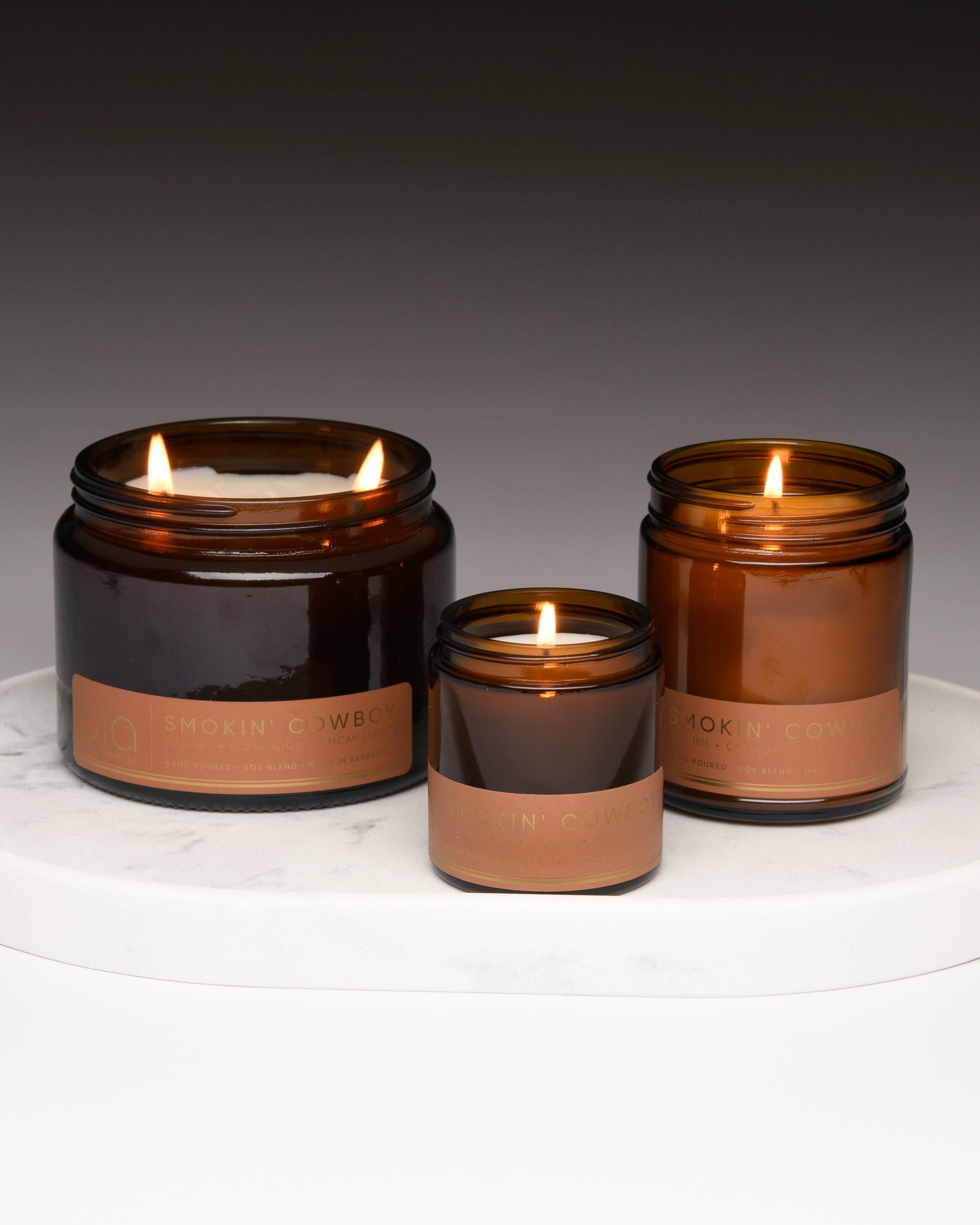 smokin cowboy bia candle co collection lit on white tray