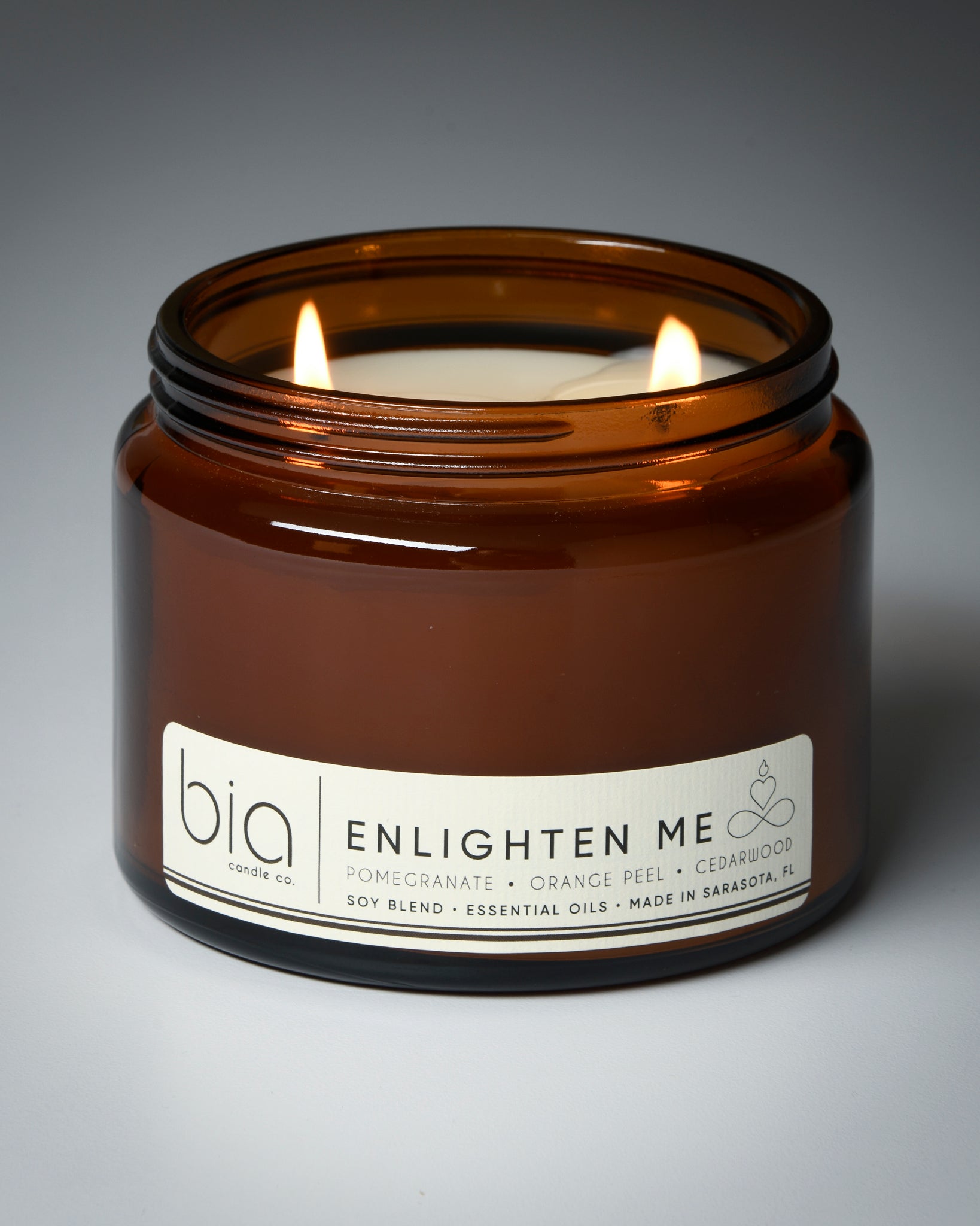 enlighten me grande two wick candle lit