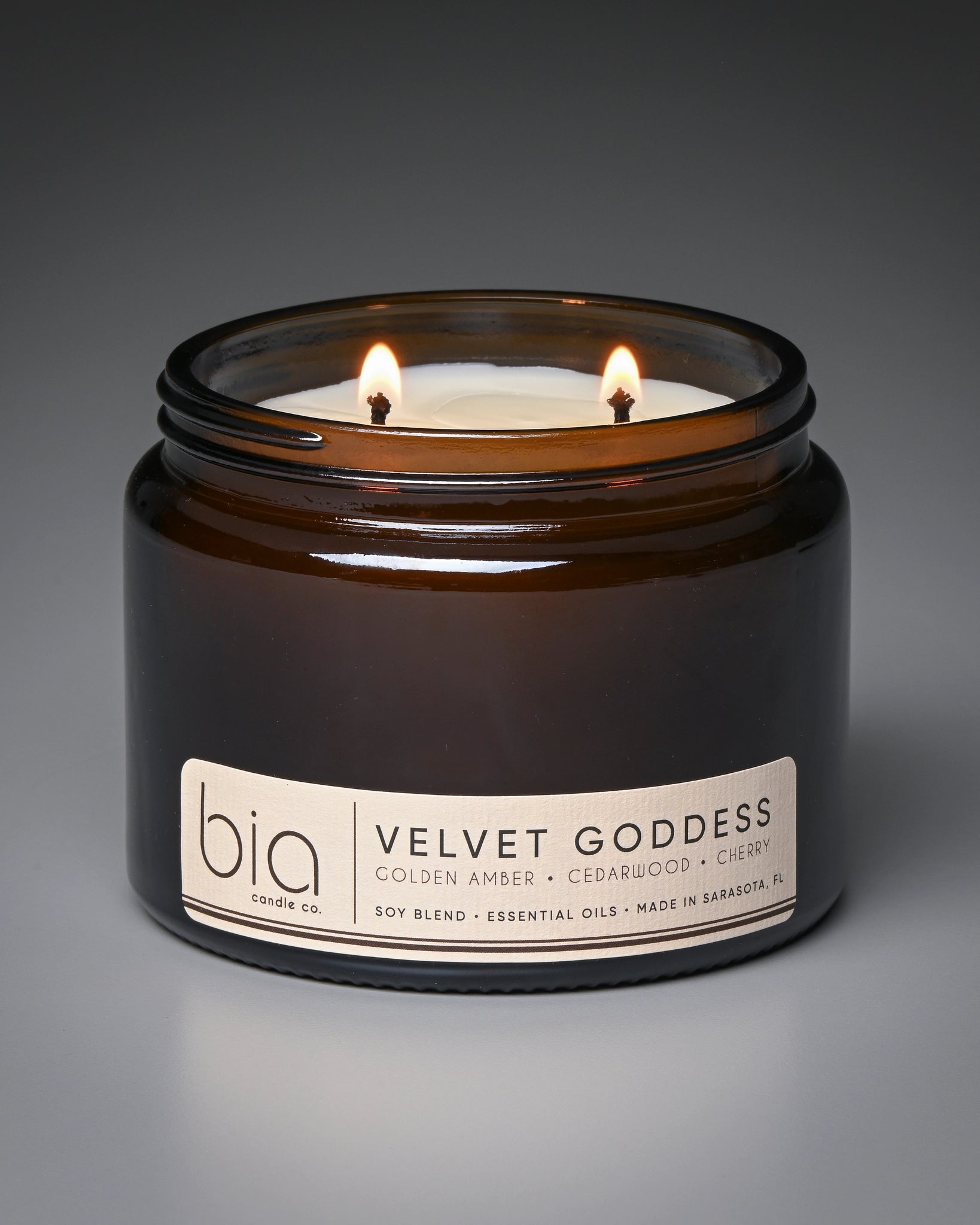 Bia candle labeled 'Velvet Goddess' on a gray background