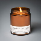 french lavender classic candle with gray background and wick lit
