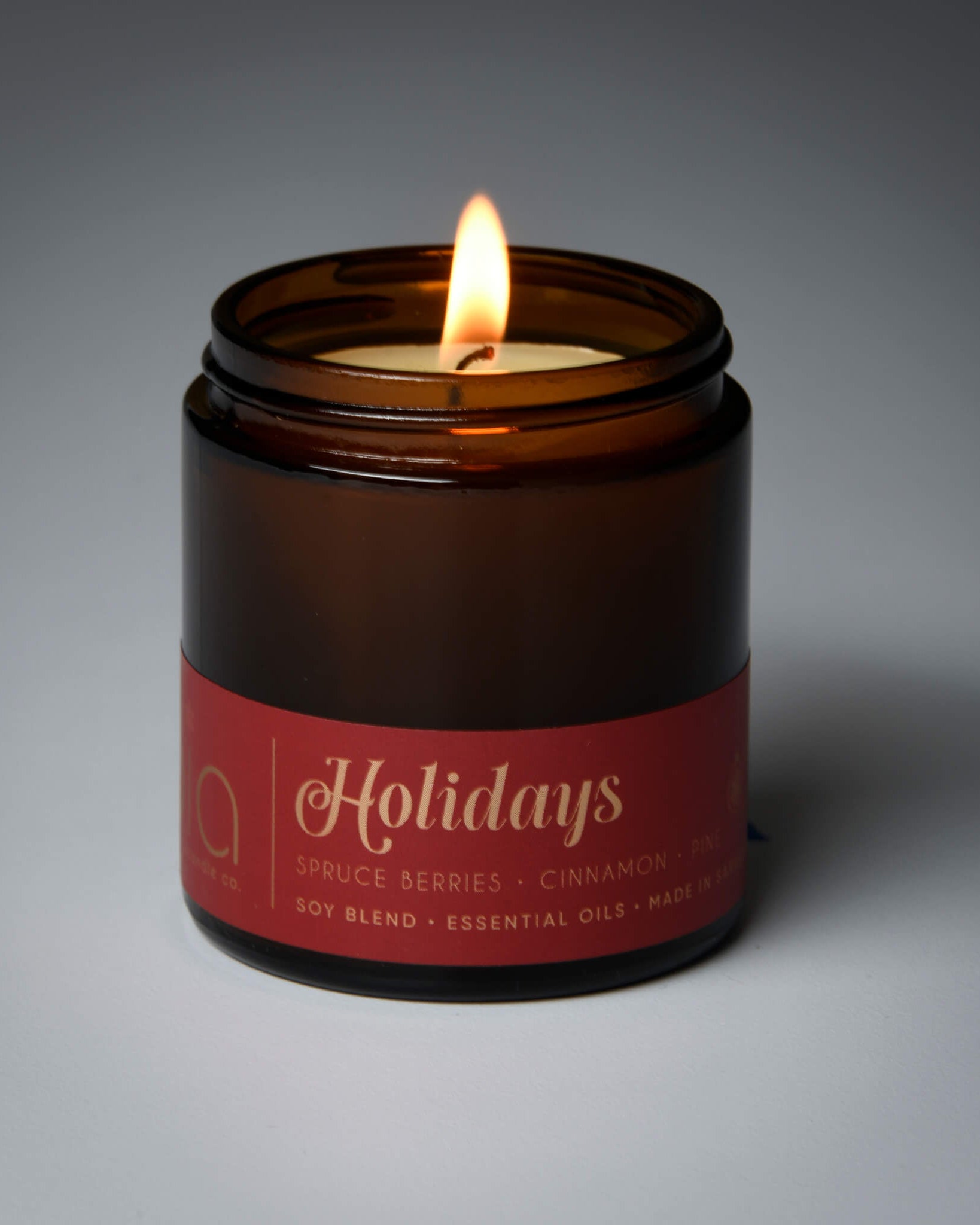 lit petite single wick holidays soy candle on grey background