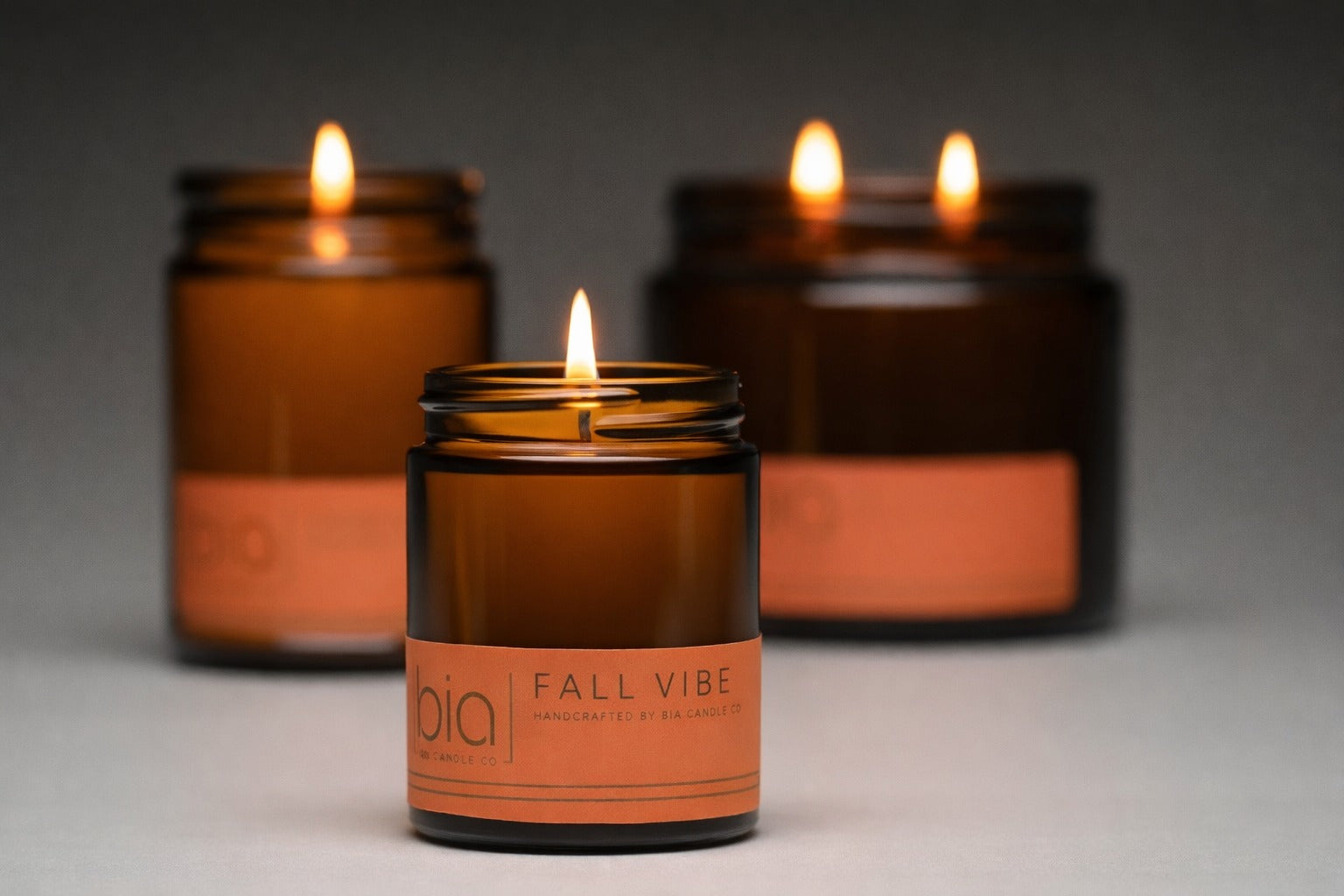 fall vibe candles lit in 3 different sizes