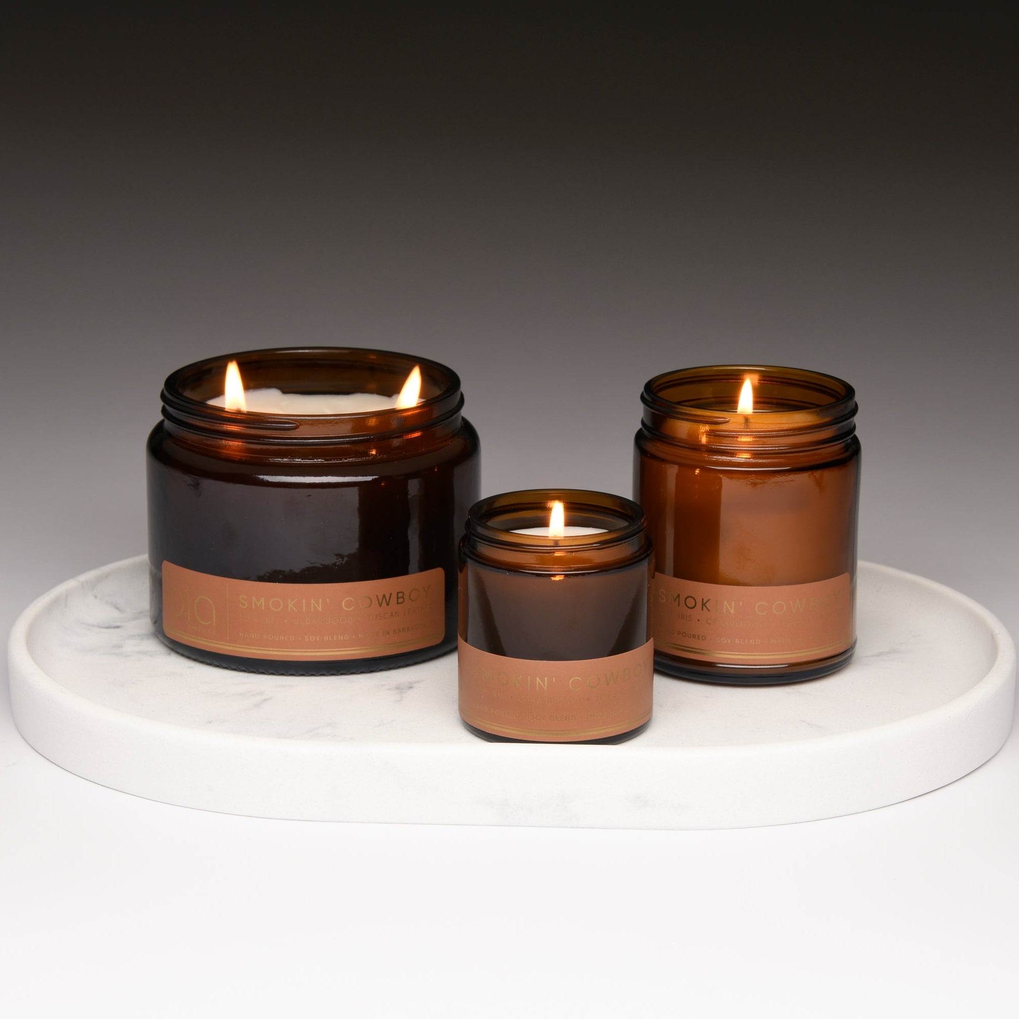 smokin cowboy bia candle co collection lit on white tray