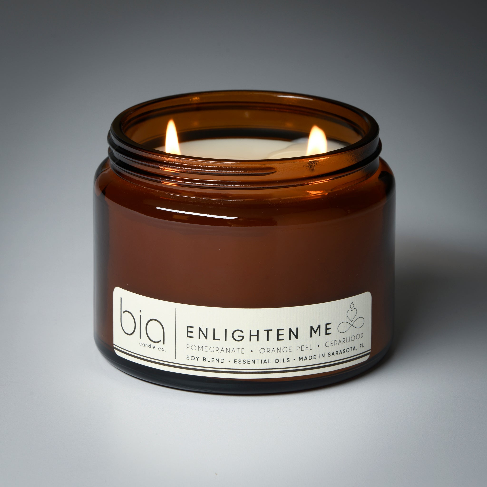 enlighten me grande two wick candle lit