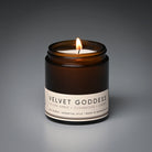 Candle in a brown jar labeled 'Velvet Goddess' on a gray background