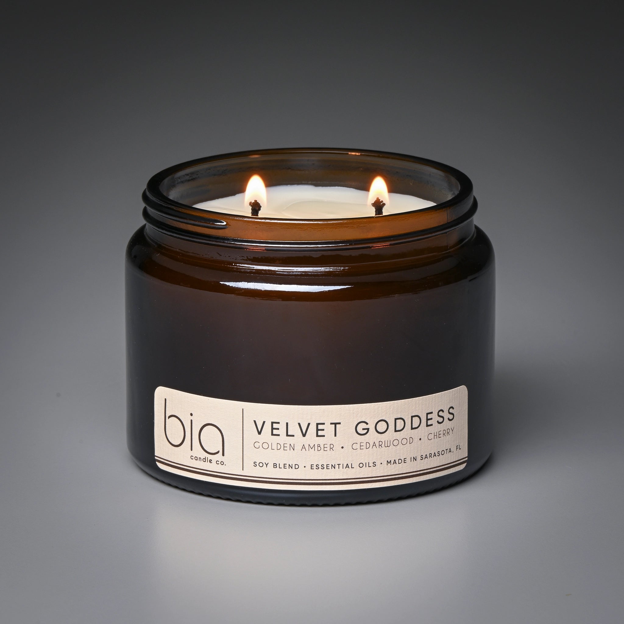 Bia candle labeled 'Velvet Goddess' on a gray background