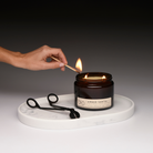 amber santal being lit with wick trimmer