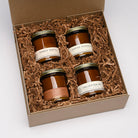 best sellers gift box, four candles with amber santal, jasmine magnolia, smokin cowboy, and enlighten me