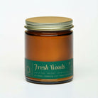 Bia Candle Co Fresh Woods soy blend candle in an amber glass jar with a gold lid and green label.