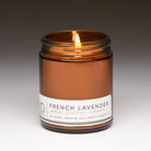 french lavender classic candle with gray background and wick lit