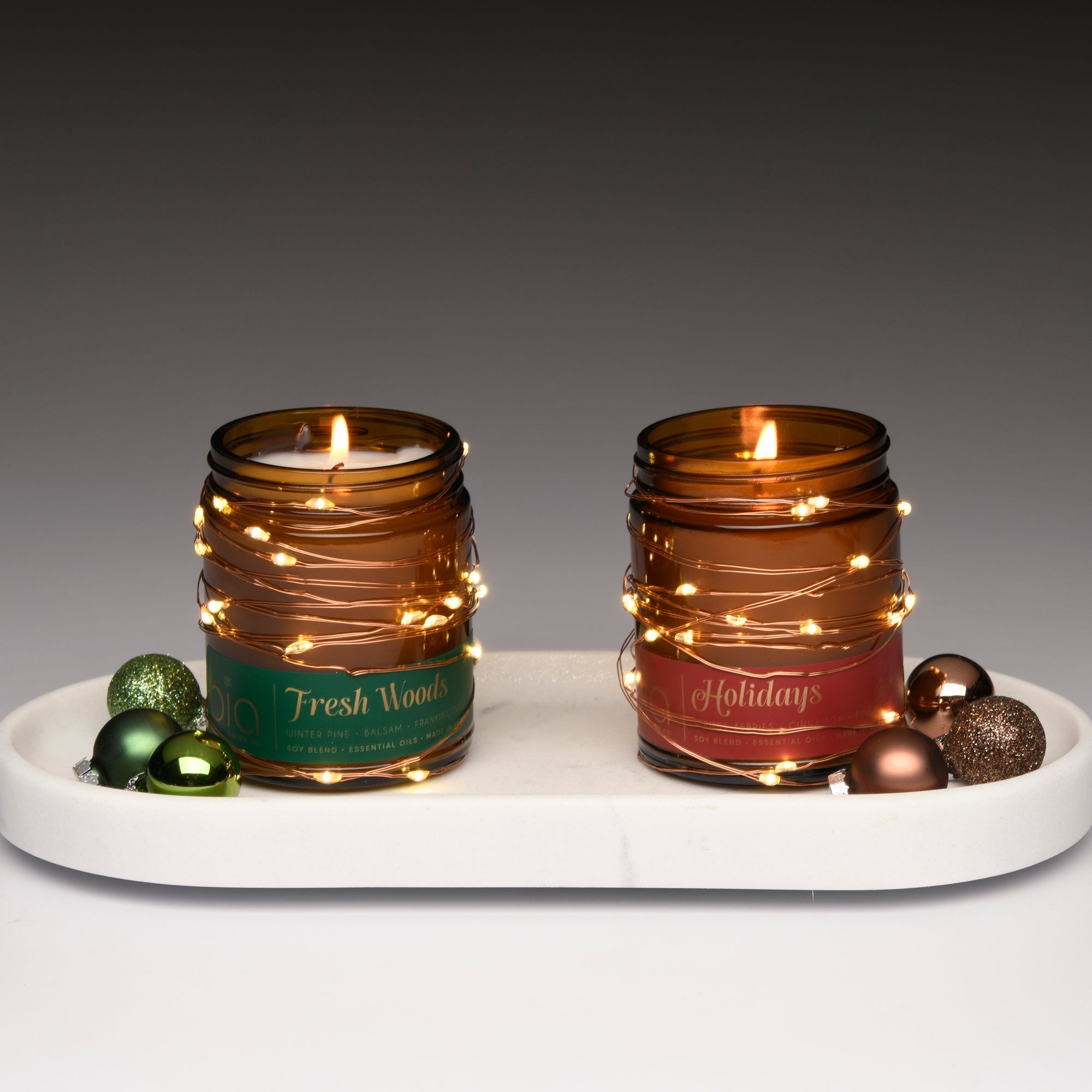 holiday scent with schristmas lights, holiday, and fressh wods with a green label