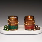 holiday scent with schristmas lights, holiday, and fressh wods with a green label