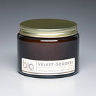 Jar of 'Velvet Goddess' candle by bia with a gold lid on a gradient background