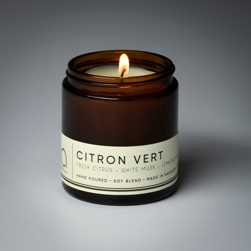 lit petite single wick citron vert soy candle on grey background