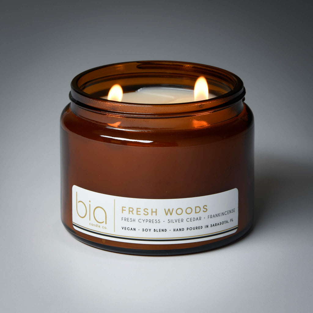 lit 2 wick fresh woods soy candle on grey background