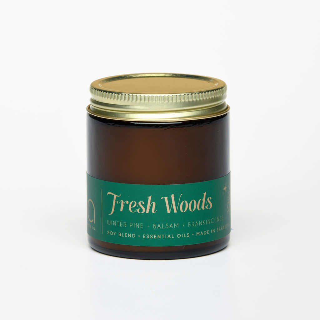 unlit and lidded single wick holiday fresh woods soy candle on white background