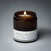 lit petite single wick fresh woods soy candle on grey background