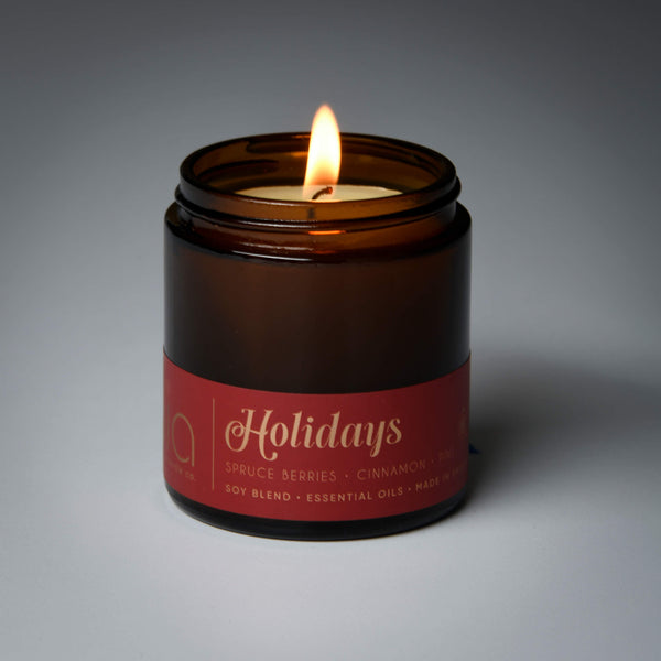 lit petite single wick holidays soy candle on grey background