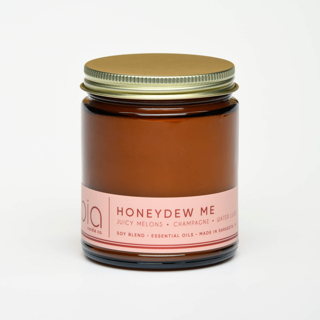 unlit and lidded single wick honey dew me soy candle on white background