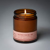 lit single wick honey dew me soy candle on grey background