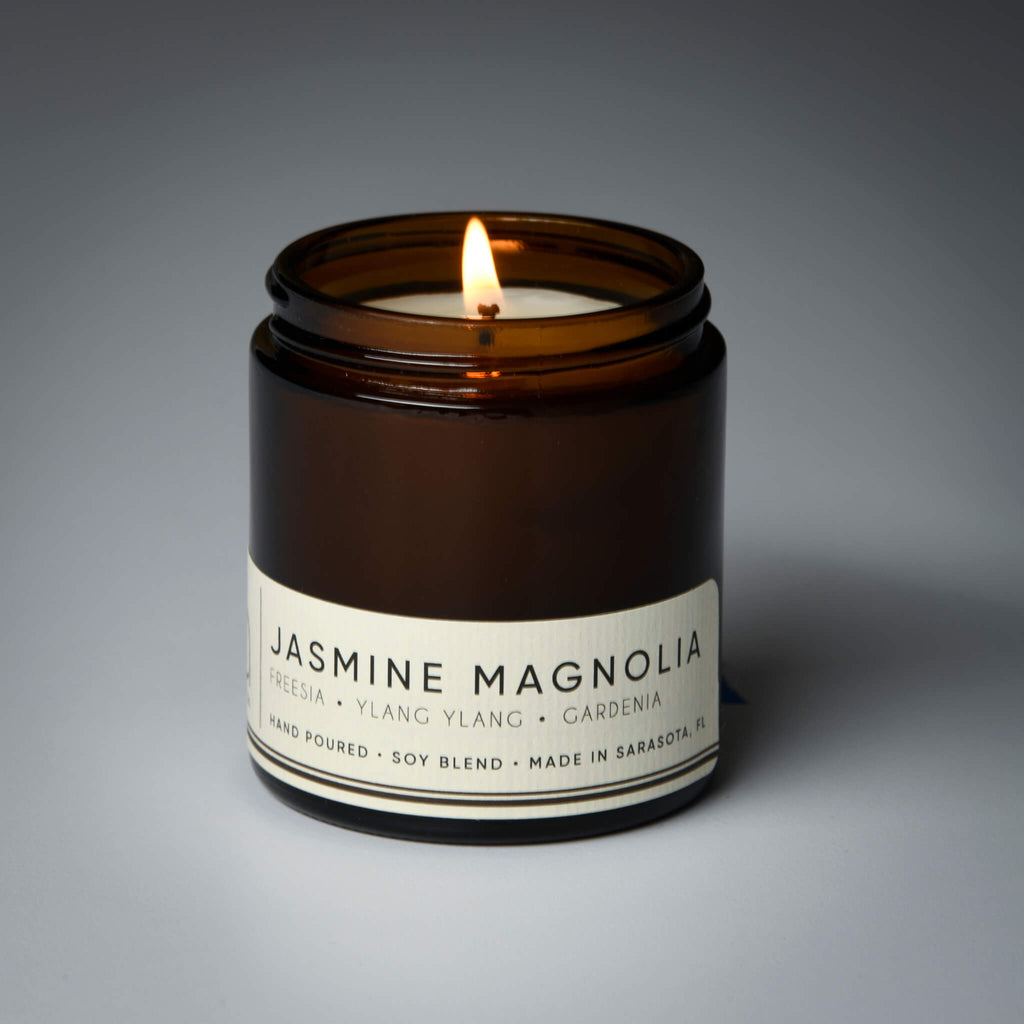 lit petite single wick jasmine magnolia soy candle on grey background