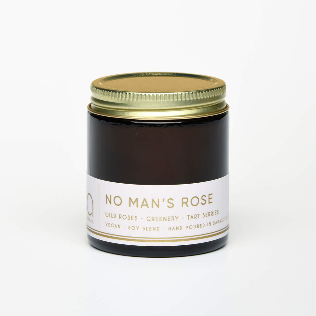 unlit and lidded petite single wick no mans rose soy candle on white background