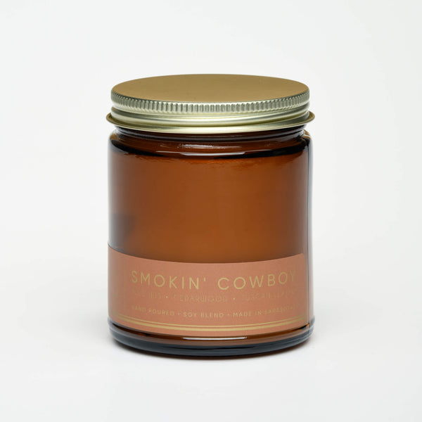unlit and lidded single wick smokin cowboy soy candle on white background