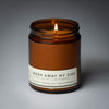 lit single wick wash away my sins soy candle on grey background